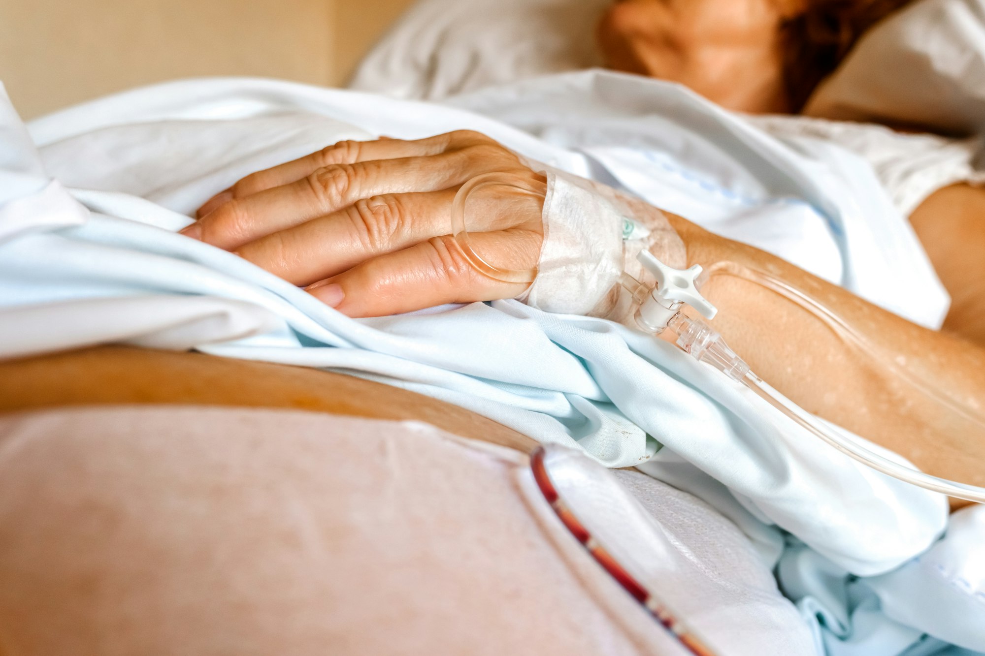Intravenous cannula placed in the hand of an elderly patient for palliative care